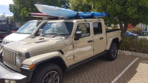 The koastal kayak enduro xtr lite on the roof of a jeep